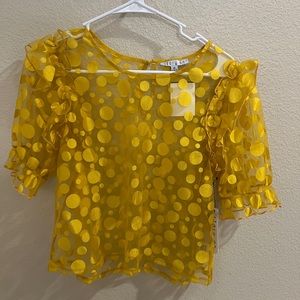 Story on yellow mesh shirt.